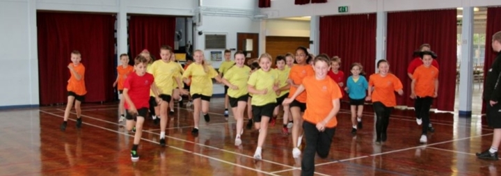 A group of children running during physical education classes