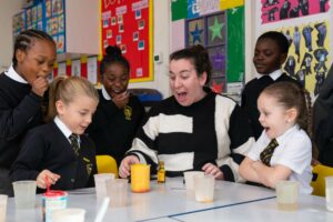 Holy Trinity students and teacher conducting a science experiment in a classroom