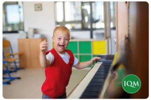 a child enjoying his regulation activity of playing the piano 