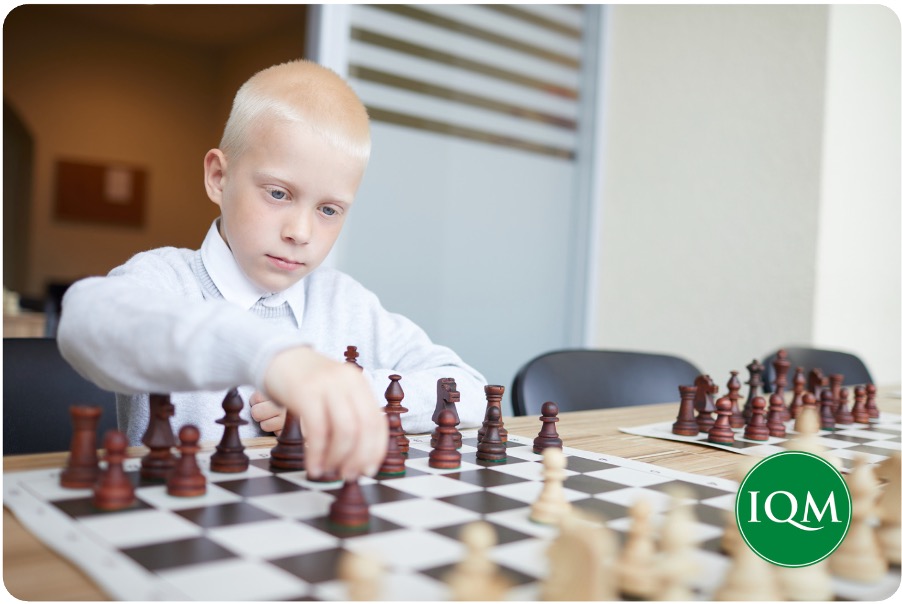 A child using strategy to play chess