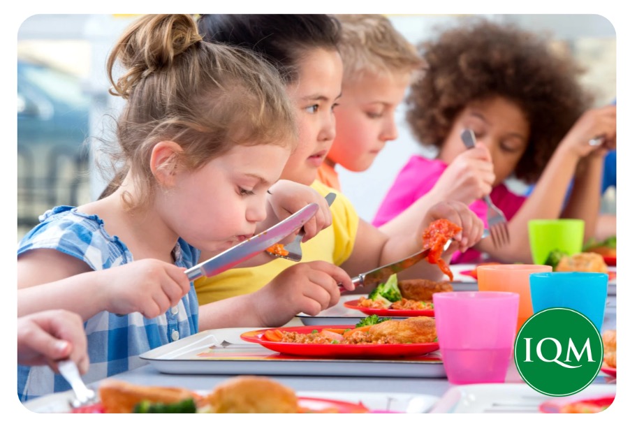 A group of children eating free school meals in school