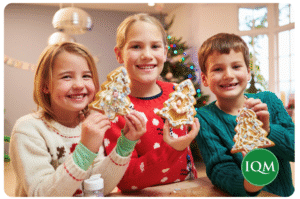School children in Christmas jumpers with IQM logo 