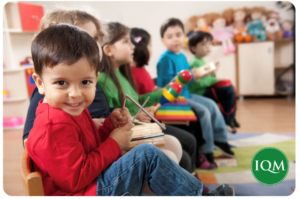 an early years child enjoying foundation subject of music lessons for expression of self