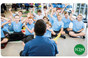 primary aged students enjoying PSED circle time with their teacher. 