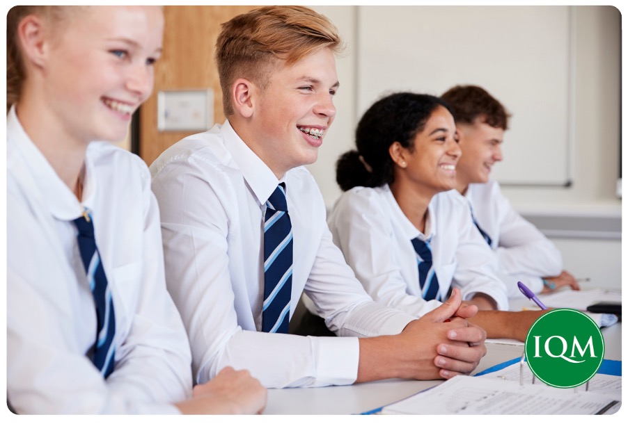 Happy secondary school aged pupils, learning and feeling a strong sense of belonging in school