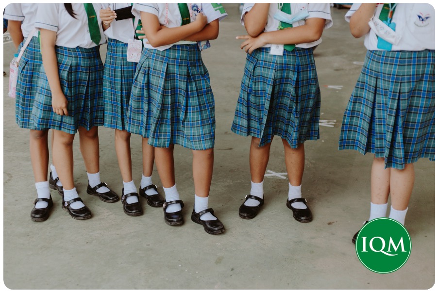 Several pupils standing in the playground of their international school in Dubai.