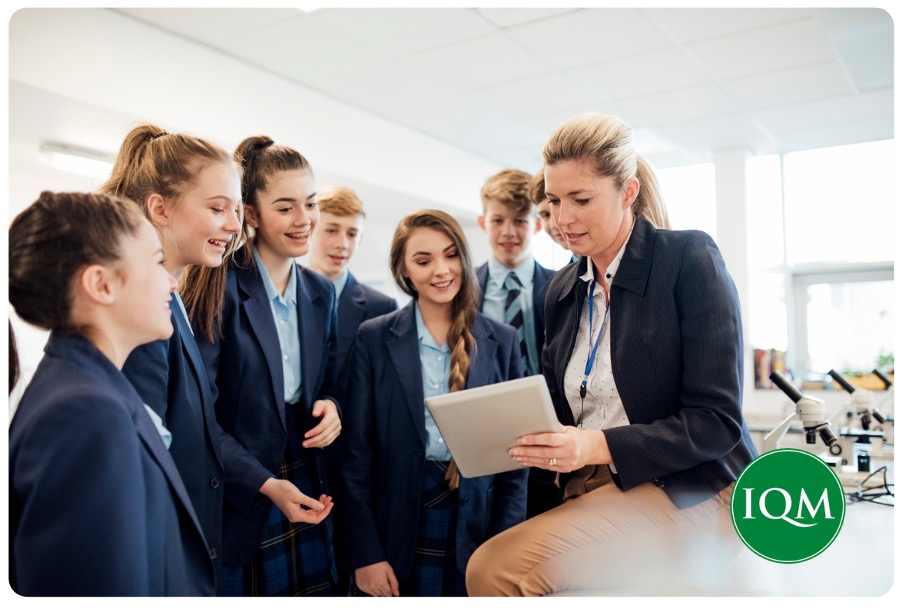 Secondary school aged pupils working with their new teacher.